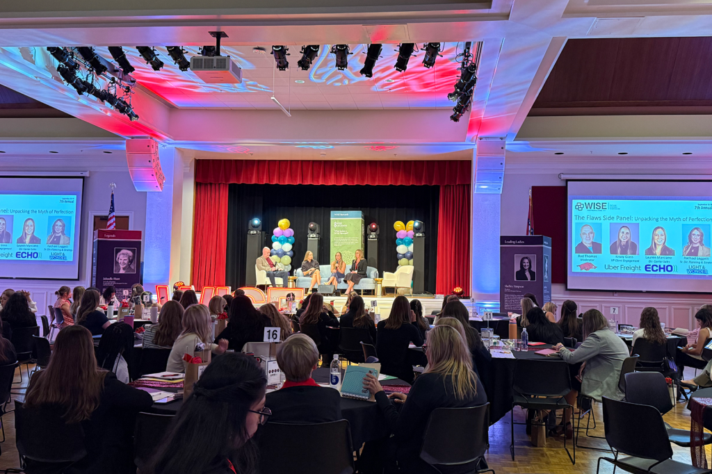 Attendees listening to conference presentation