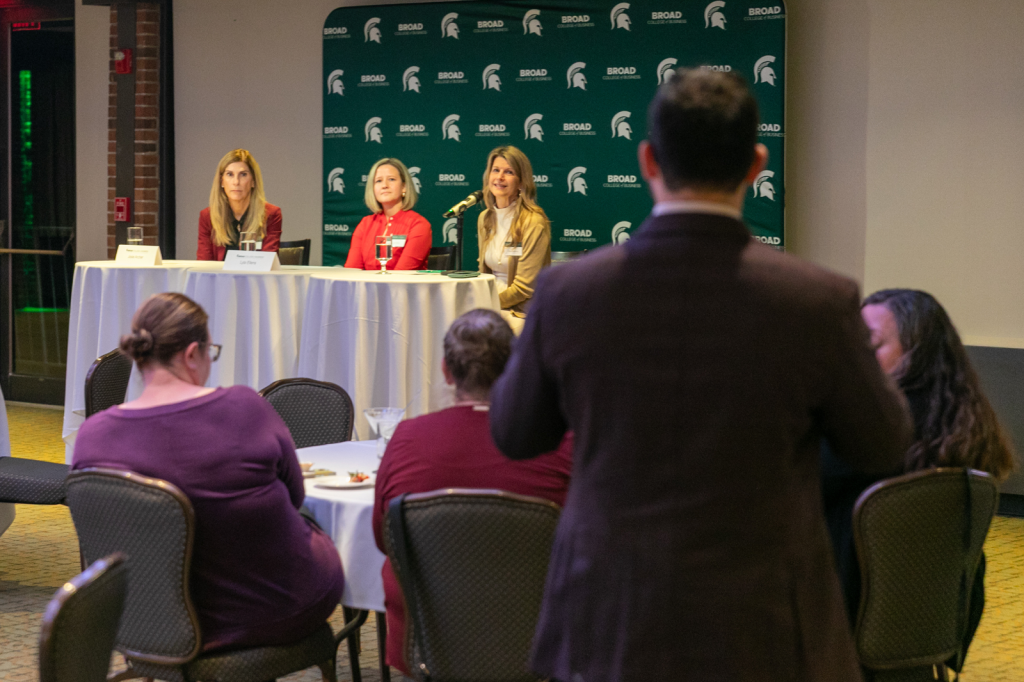 Panelists listening to standing participant