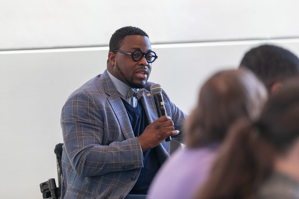 Speaker seated with microphone