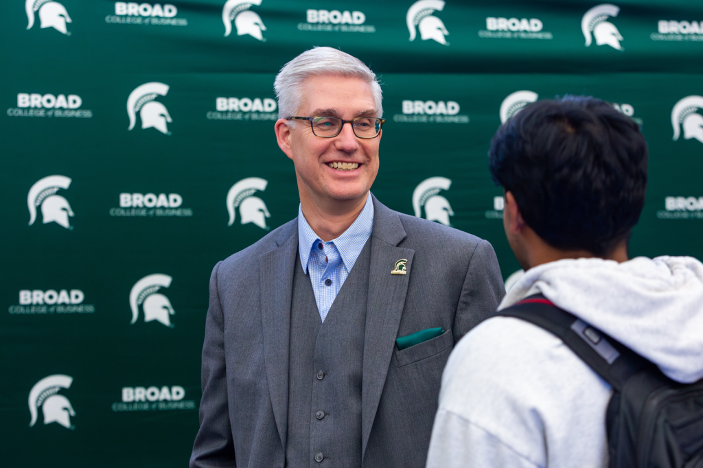 Man smiling at student