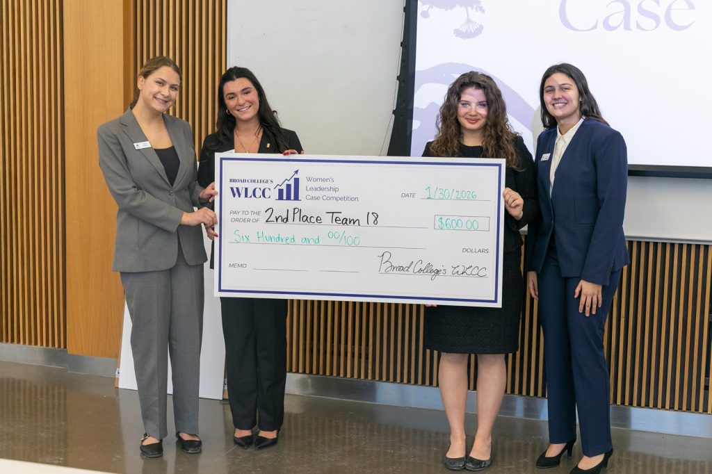 2nd place team holding oversized check