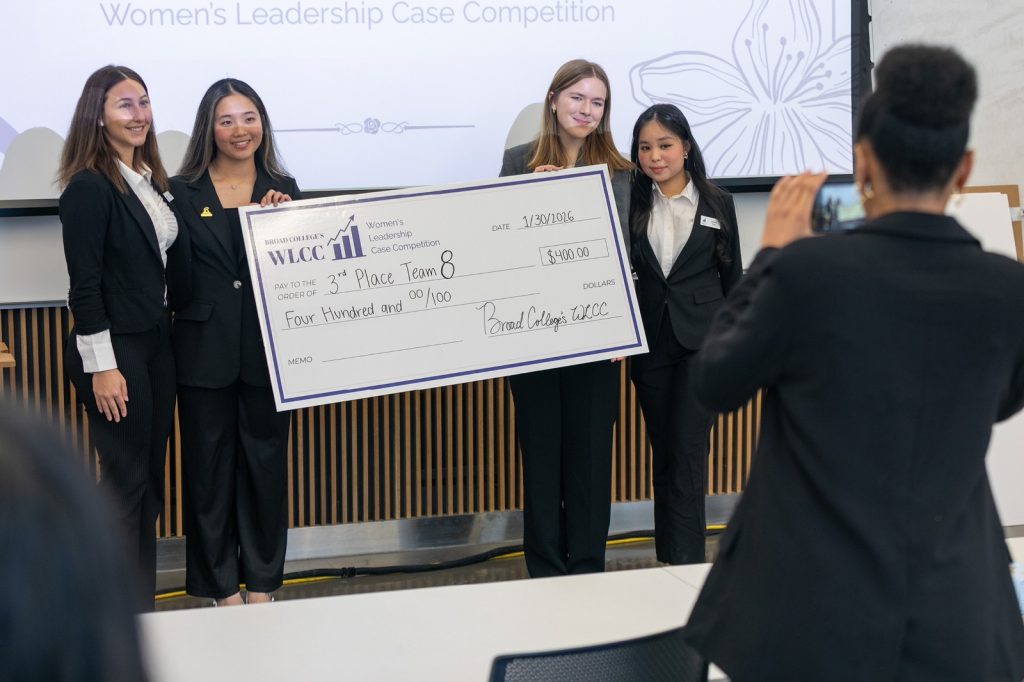 3rd place team holding oversized check