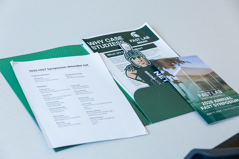 The FAST Symposium packet that was given out to participants. It contains a list of attendees and speakers, some broad college of business merchandise, and a FAST Symposium pamphlet.