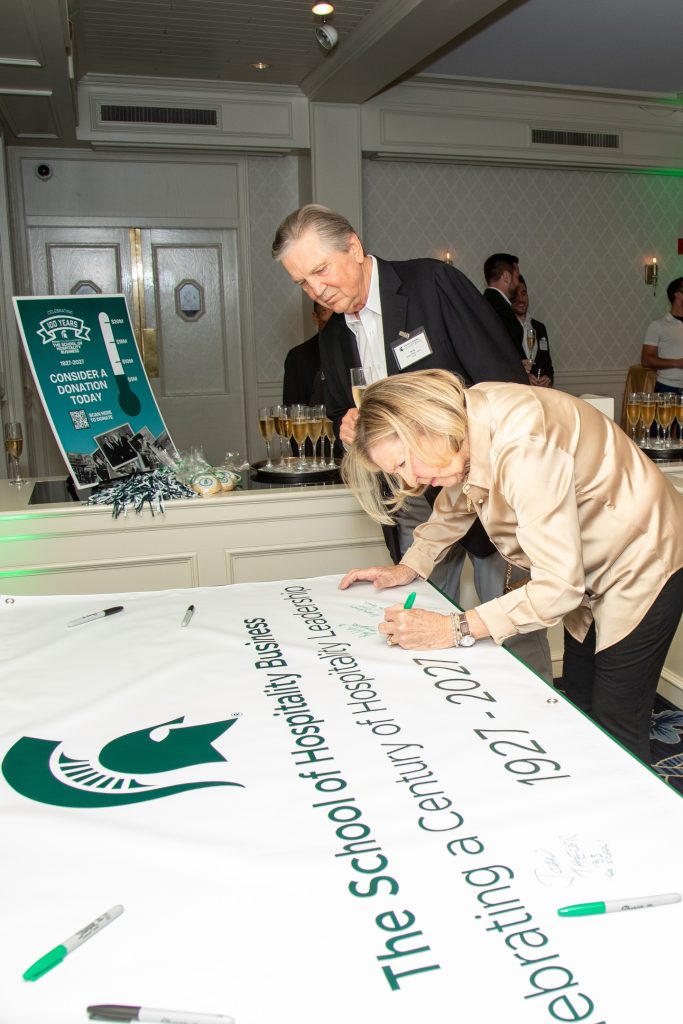 Guests signing celebratory banner