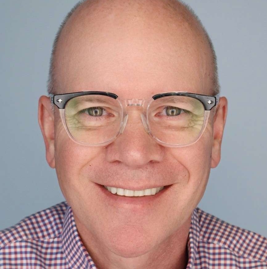 Paul Edwards headshot - man with glasses smiling