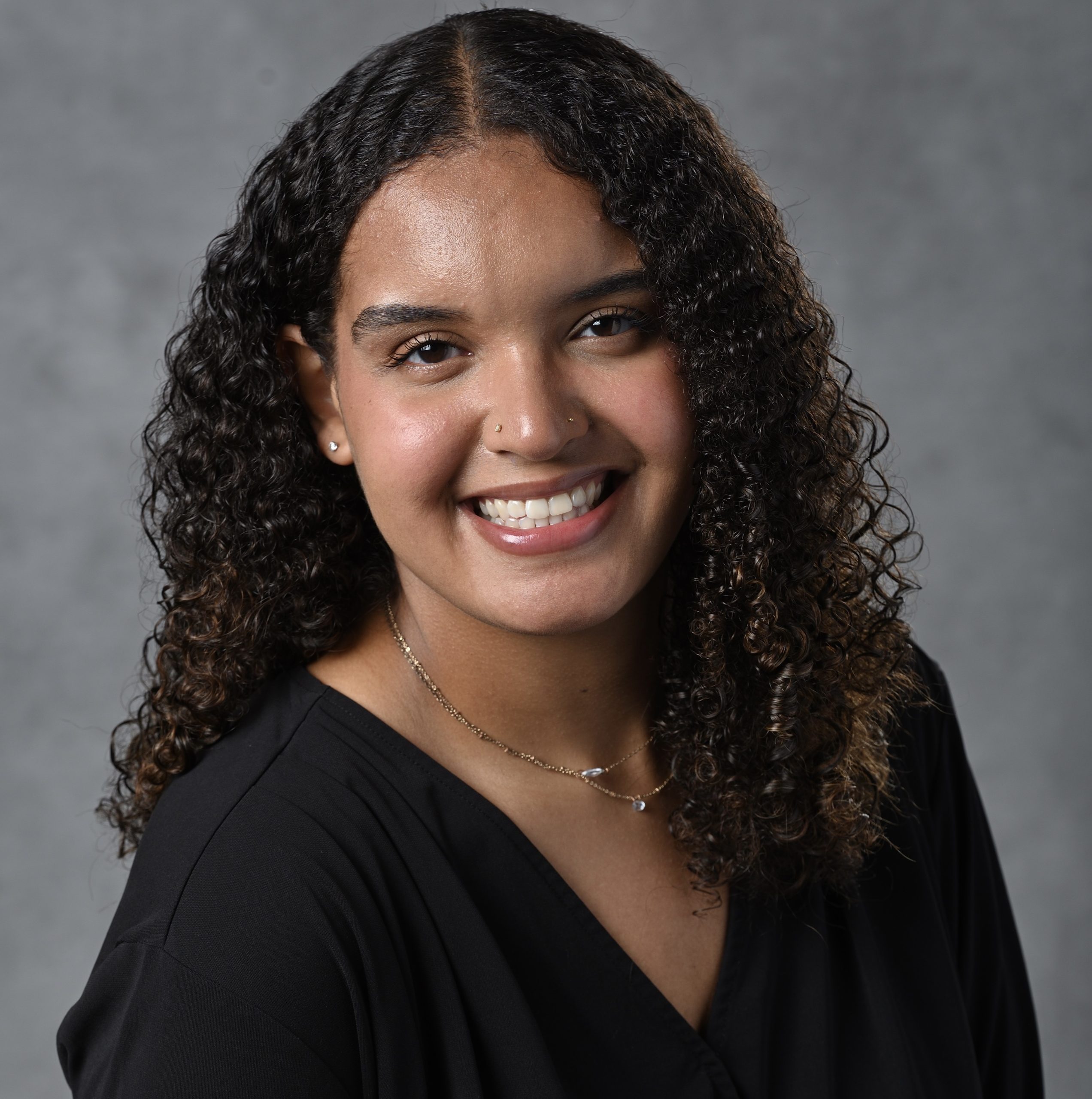 Alyssa Lowe headshot - woman in black shirt smiling