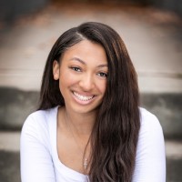 Young woman in a white shirt with a big smile