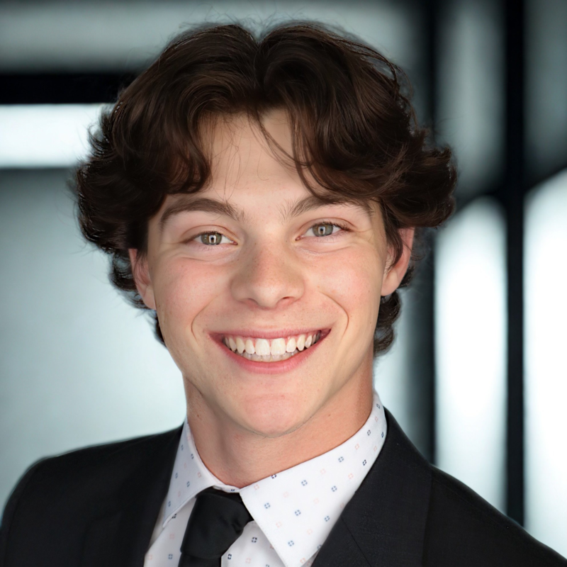 Young man in a business suit smiling at the camera