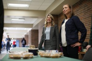 Elizabeth Richter, and Cheri DeClercq sell pies to raise money for the Greater Lansing Food Bank.