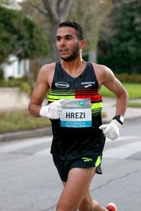 Mohamed Hrezi running down street.