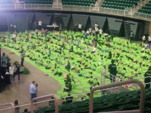 empowHER attendees sitting on a sea of green mats