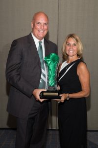 John Duffey and his wife pose for a picture with his award
