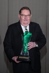 Patrick Donelly poses with his award