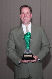 Phil Zeller poses with his award