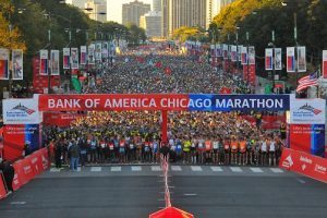 A mass of runners stand behind the Bank of America Chicago Marathon start line