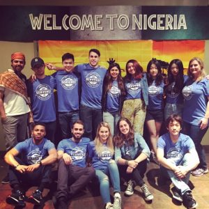 "Welcome to Nigeria" reads a sign above the group on alternative spring break