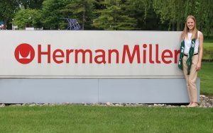 Katlynn Roden poses next to the HermanMiller sign