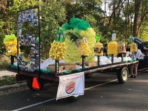 The Broad College 2017 homecoming parade is bordered with DIY pineapples. The float sponsored by Burger King.