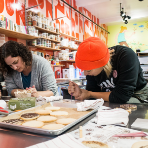Clark (right) takes a hands-on approach in her renowned confectionery and creatively changes her menu to reflect events, seasons, and themes from her city and the world of food.