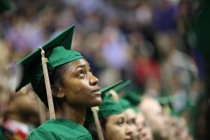 A Broad College of Business graduate awaits the start of commencement exercises Saturday, May 5 at the Breslin Center. Photo by Matt Mitchell