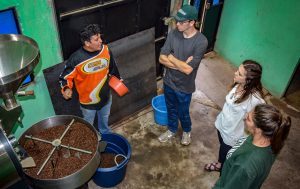 Nate Caverly (BA Accounting ’19), Morgan Burns (BA Accounting ’18), and Jaimee Beckett (BA Computer Science ’19) learning to roast coffee with Victor Catavi in Guatemala