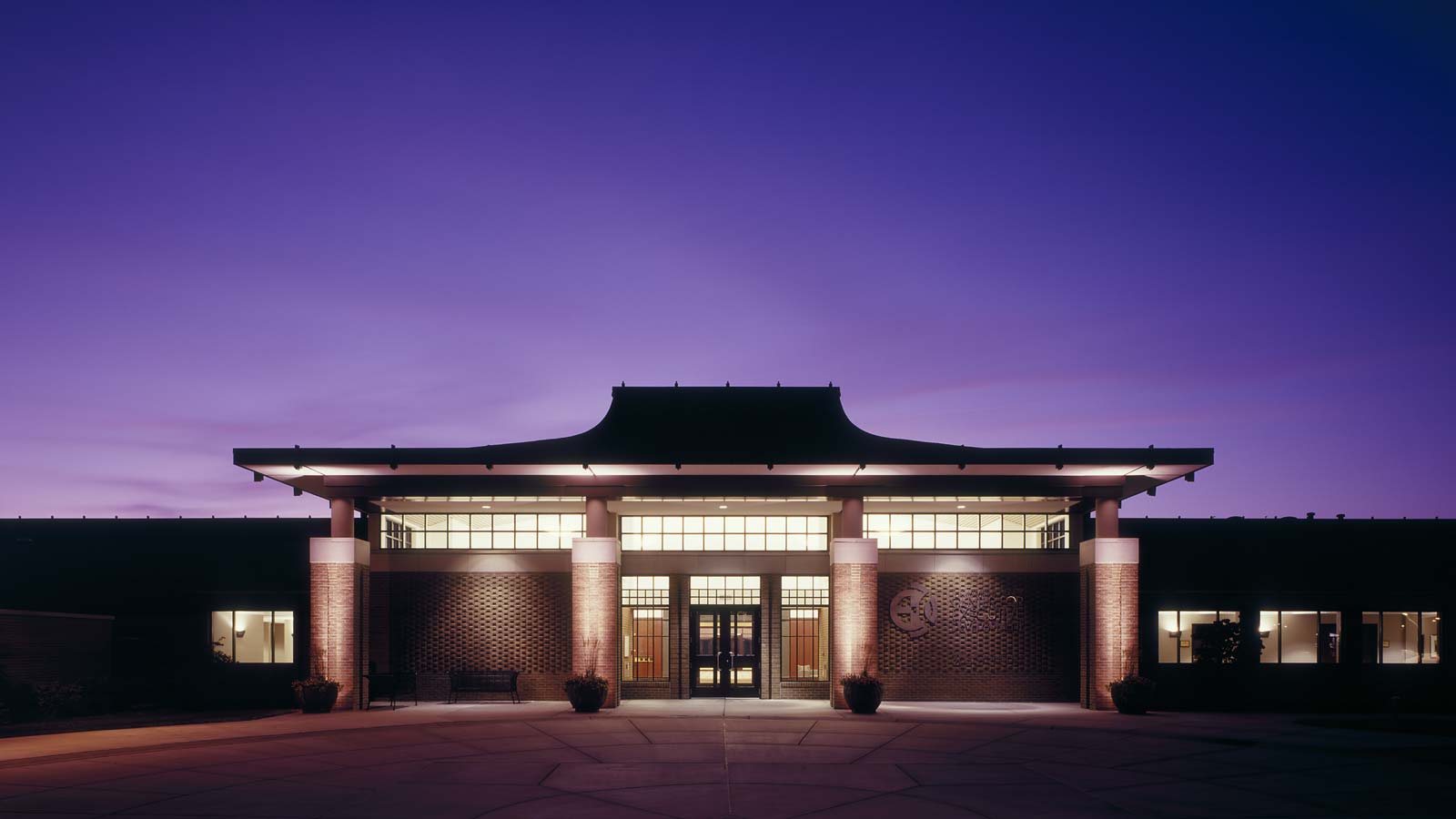The front exterior entrance to the Henry Center for Executive Development, as seen at night.