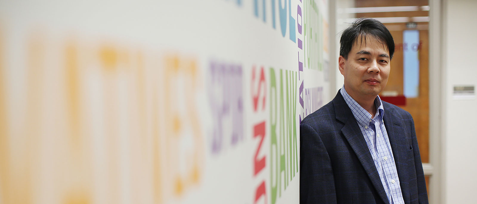 Department Of Finance Eli Broad College Of Business Michigan - msu finance faculty member hayong yun poses for a portrait leaned against a wall filled