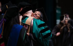 An Executive MBA graduate celebrates her program completion. Photo by Erin Groom