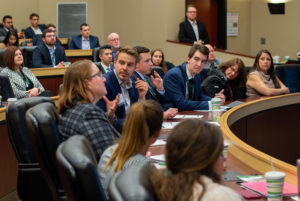 Broad Full-Time MBA alumni judges and students discuss and listen to presentations.