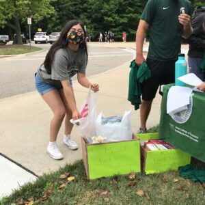 A female student donated nonperishable food items to the MSU Foodbank as part of this year's Residential Business College Welcome Events on-campus.