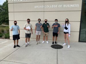 Six students from the Broad College’s Residential Business Community pictured outside the Minskoff Pavilion, wearing masks, for this year's welcome event.