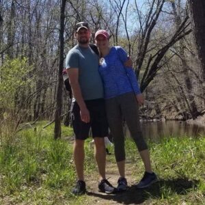 Trevor Leveille and Ashley Day (MBA '21) outside in a natural area on a sunny day.