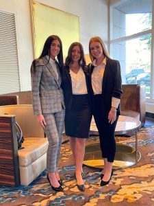 Undergrad students Nadia Cismesia, Emma Toppi and Shavrina Polina in business formal attire