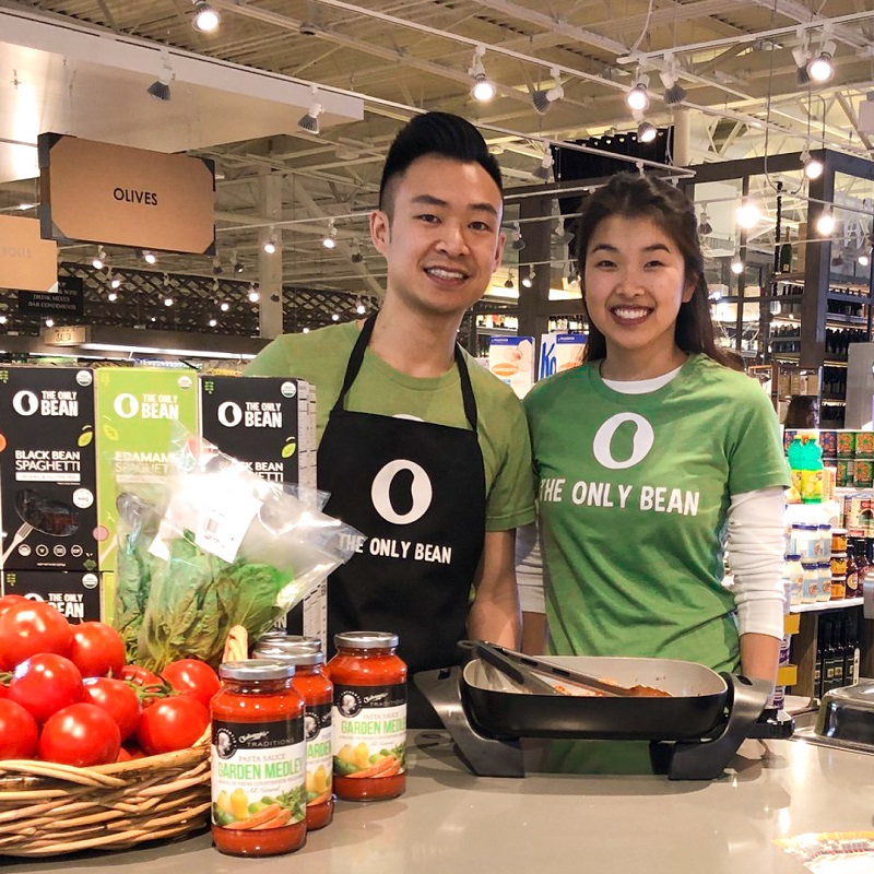 Brian Lai and Kristine Yang do a cooking demo at a grocery store with their products from The Only Bean.