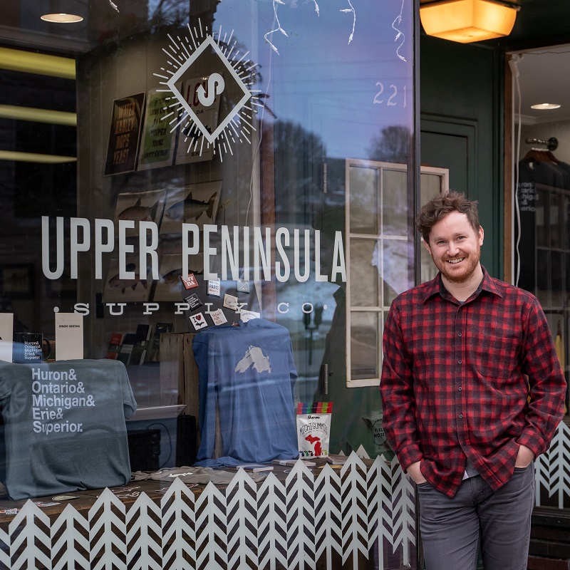 Bugsy Sailor stands outside his storefront for Upper Peninsula Supply Co.