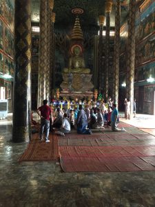 EMBA students in a Buddhist temple in Vietnam receiving blessings from monks.